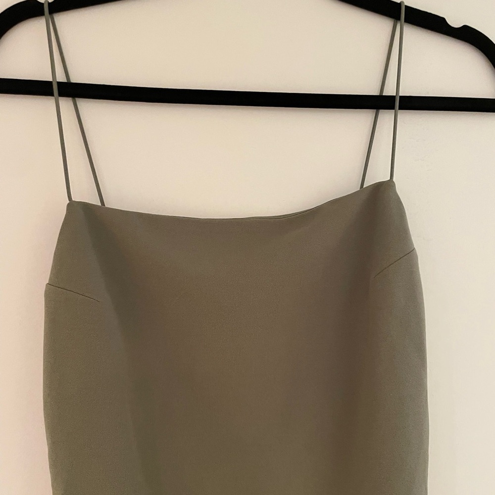 Khaki green bodycon dress with zipper closure and elastic straps.
